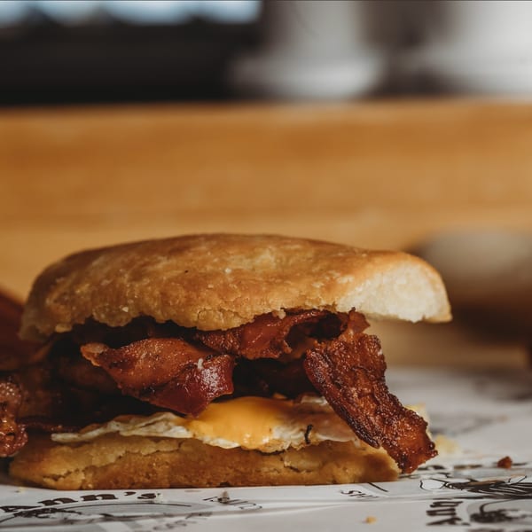 Lou Ann's Biscuits & Burgers' breakfast biscuit with crispy bacon and a fried egg.